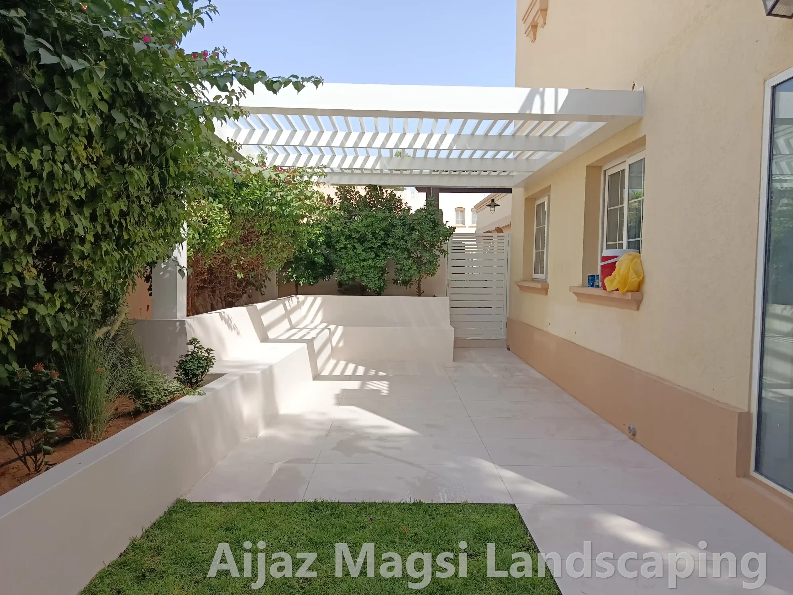 Modern covered outdoor patio with kitchen setup and tiled floor design
