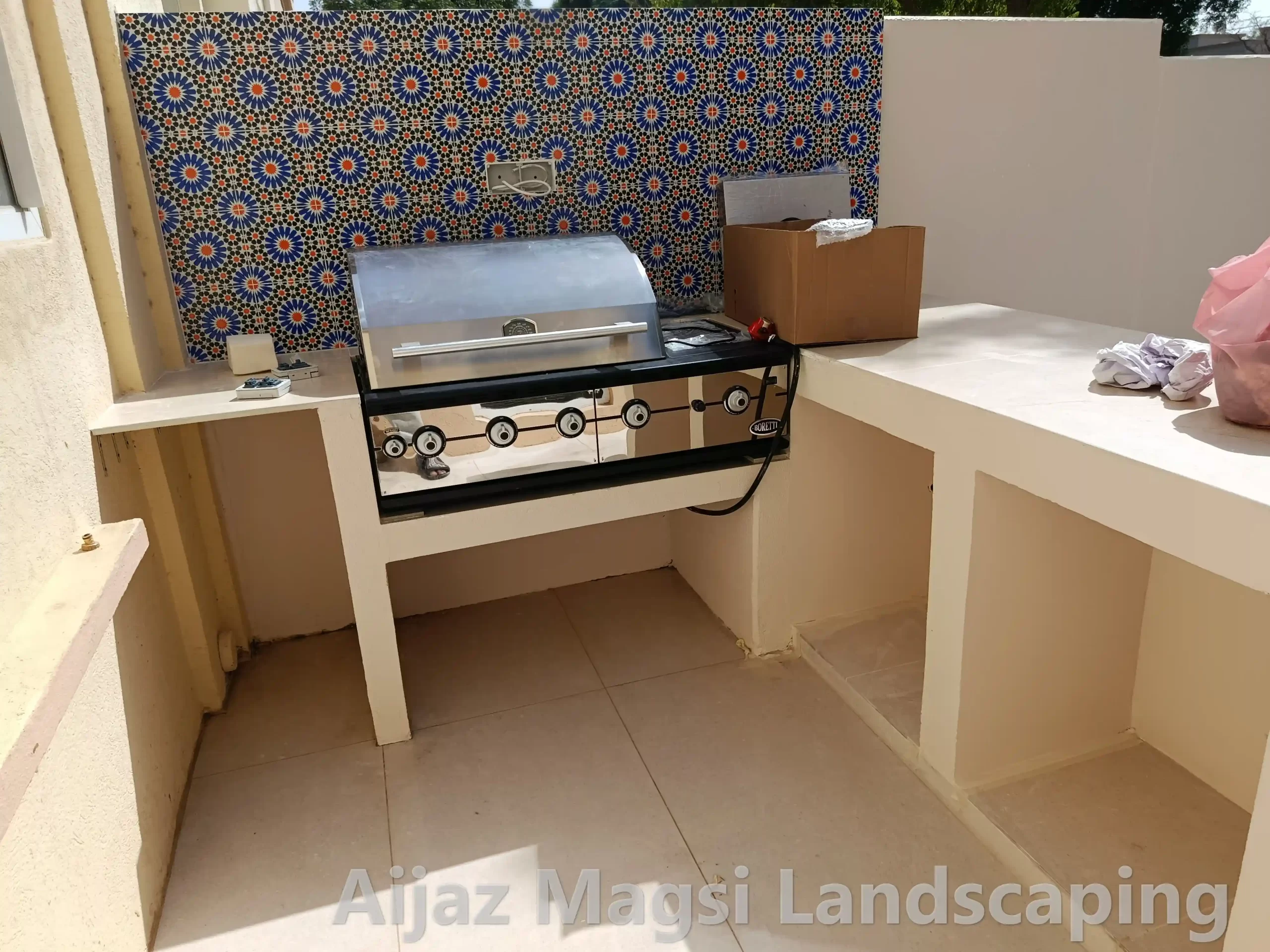 Custom outdoor kitchen counter with built-in BBQ grill for villa patio