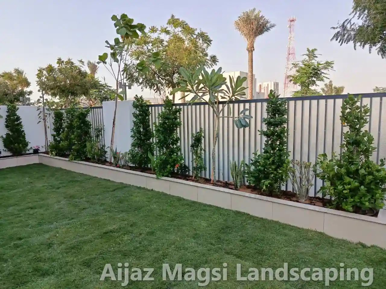 Decorative garden planter with fresh green shrub installation for villa outdoor